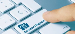 A finger pressing a keyboard key labeled "Accident Report," featuring an icon of a document folder.